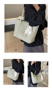 Macro detail of sage green woven tote bag with decorative silk scarf on the handle