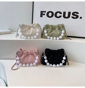 Group display of ruched cloud bags in white, green, pink, and black with beaded handles
