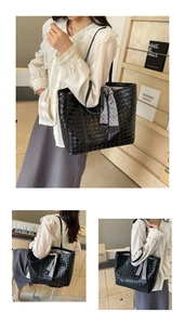 Detail of black woven tote bag featuring decorative geometric scarf and large capacity
