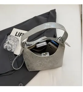 Interior view of silver metallic handbag showing spacious capacity for phone and wallet