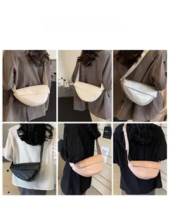 Detail view of four stylish half-moon bags in beige, silver, black, and pink colors