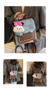 Detail of vintage denim backpack with star patches and plush dog charm on the handle