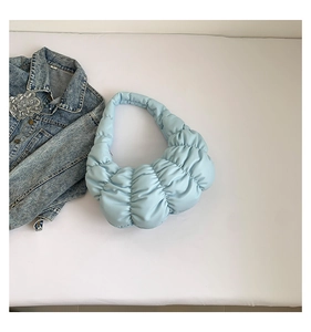 Detail of light blue ruched cloud bag with quilted texture and soft padded shoulder strap