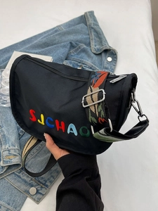 Minimalist black nylon crossbody bag with colorful embroidery and ethnic style wide strap
