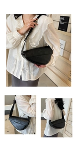 Detail of black pleated croissant bag with BKN BKN lettering on human model