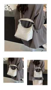 Close-up of silver cracked texture leather bag with adjustable strap and minimalist design