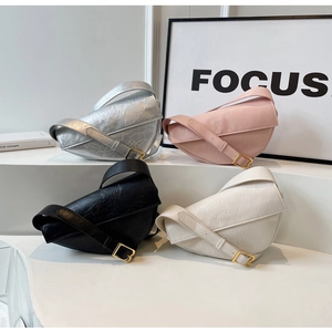 Detail of pleated dumpling bags in silver, pink, black and white on display stand