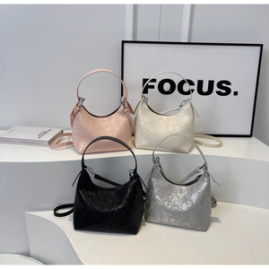Detail of four metallic crackle finish half-moon handbags in pink, white, black and silver