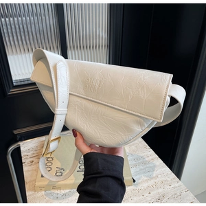 Detail view of white ruched leather bag with AKN logo and gold metal buckle
