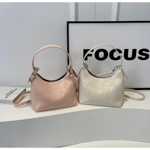 Detail of hobo bag with metallic cracked texture in pink and off-white finishes