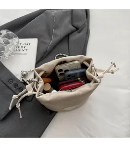 Top view of beige drawstring bucket bag showing interior space for phone and wallet