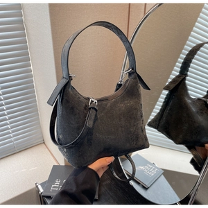 Detailed close-up of a black vintage crossbody bag with a matte textured finish