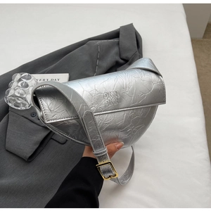 Close-up of silver pleated hobo bag with AKN logo and golden adjustable buckle