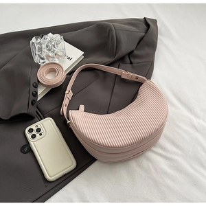 Detailed macro view of the light pink pleated dumpling bag with adjustable strap