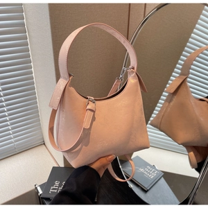Detail of pink pearlescent underarm bag with adjustable strap and silver metal buckle