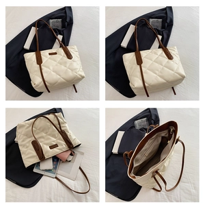 Detail view of large quilted tote bag interior capacity for tablet and phone