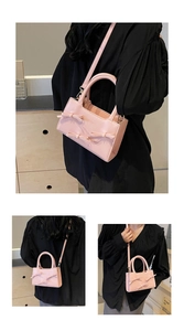 Detailed view of pink sweet tote bag featuring elegant bow and pearl decorations
