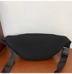 Détail du sac de poitrine en nylon noir avec une boucle de fermeture en plastique robuste