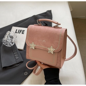 Detail of pink mini backpack with star metal accents and decorative beaded edges