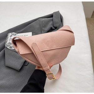 Detailed close-up of pink pleated texture bag with metallic gold buckle and logo