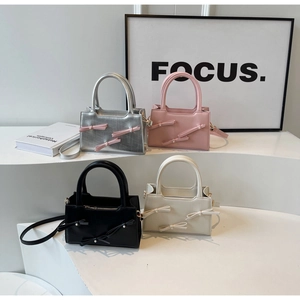 Detailed display of four colors of butterfly tote bags with pearls and straps