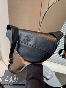 Minimalist black pleated half-moon shoulder bag with retro leather texture and strap