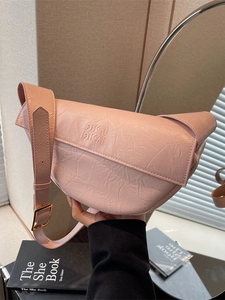 Pink crescent shoulder bag with pleated texture and wide strap for casual wear