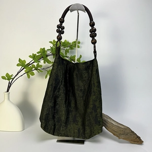 Moss green tote bag with vintage texture and dark brown wooden beaded shoulder strap