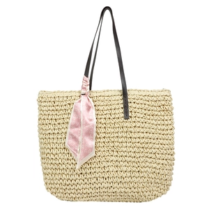 Large straw tote bag with brown leather straps and pink heart silk scarf for summer beach