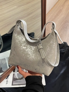 Chic silver metallic pleated underarm bag with industrial texture and adjustable strap