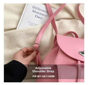 Detail view of adjustable pink synthetic leather straps with silver metal buckles on the bag