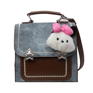 Retro denim and leather shoulder bag with star buckles and plush charm on white background