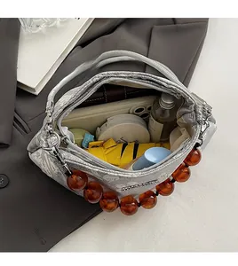 Interior detail of jacquard floral bag showing ample space for phone and cosmetics
