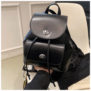 Detail of black PU leather backpack showing silver twist-lock closure and smooth finish