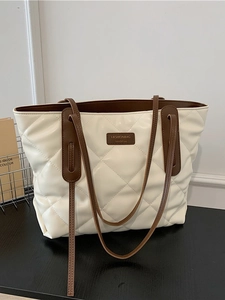 Chic quilted tote bag for women featuring creamy white leather and dark brown handles