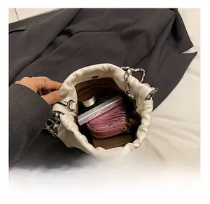 Interior view showing capacity for makeup and daily items in the white bucket bag