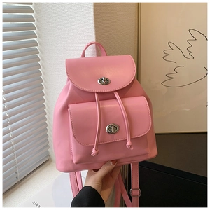 Detail of pink PU leather mini backpack with silver metal twist lock and drawstring closure
