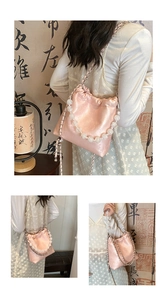Detail of pink silk drawstring bag with pearlescent bead chain and metal strap