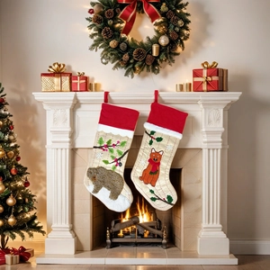 Christmas stockings set with bear and fox embroidery hanging by a festive fireplace