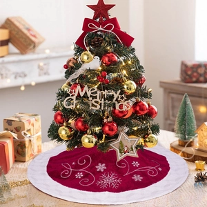 Détail du tapis de sapin de Noël bordeaux avec broderie de flocons blancs et velours