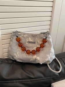 Silver beaded handbag for women featuring white butterfly prints and amber bead handle