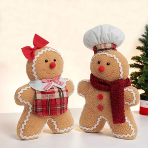Plush gingerbread man and woman dolls with festive scarves and chef hat decor