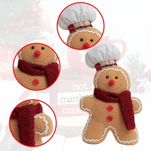 Detail view of gingerbread plush with chef hat and red knitted scarf for Christmas decor