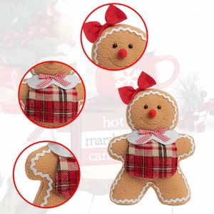 Close-up of plush gingerbread man toy featuring festive red bow and plaid apron details