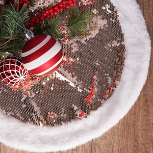 Sequin Christmas tree skirt with champagne gold glitter and white faux fur trim on wood