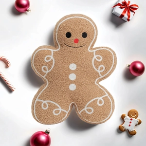 Close-up of brown gingerbread man plush pillow with festive Christmas ornaments
