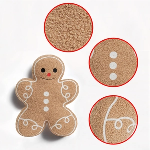 Detail of plush gingerbread man pillow showing teddy fleece texture and embroidery