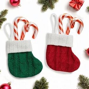 Knitted Christmas stocking gift bags in red and green with candy canes on white background
