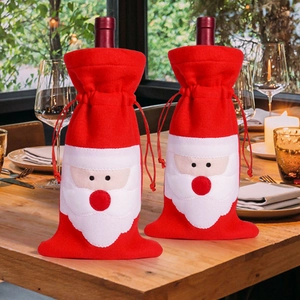 Detailed view of red felt Santa wine bottle covers with white beard on a festive table