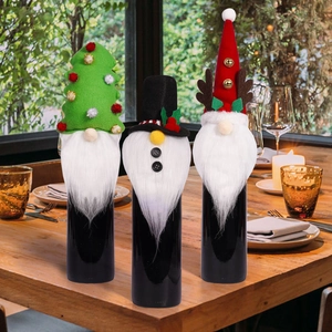 Close-up of three festive Christmas gnome wine bottle covers with tree and elk horn hats